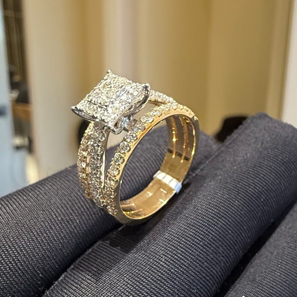 Gold ring with diamond accents on a gray surface