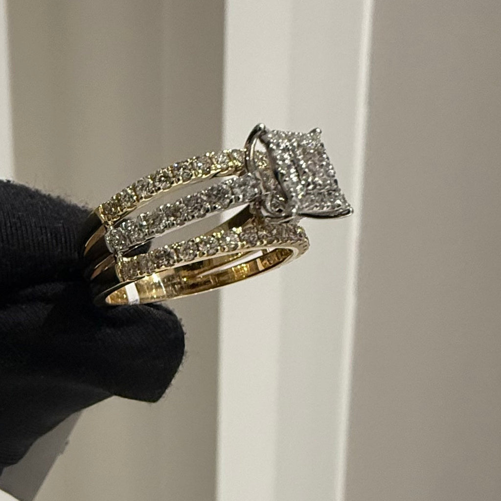 Diamond ring held by a gloved hand against a neutral background