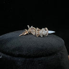 Diamond earrings on a black cushion with a dark background