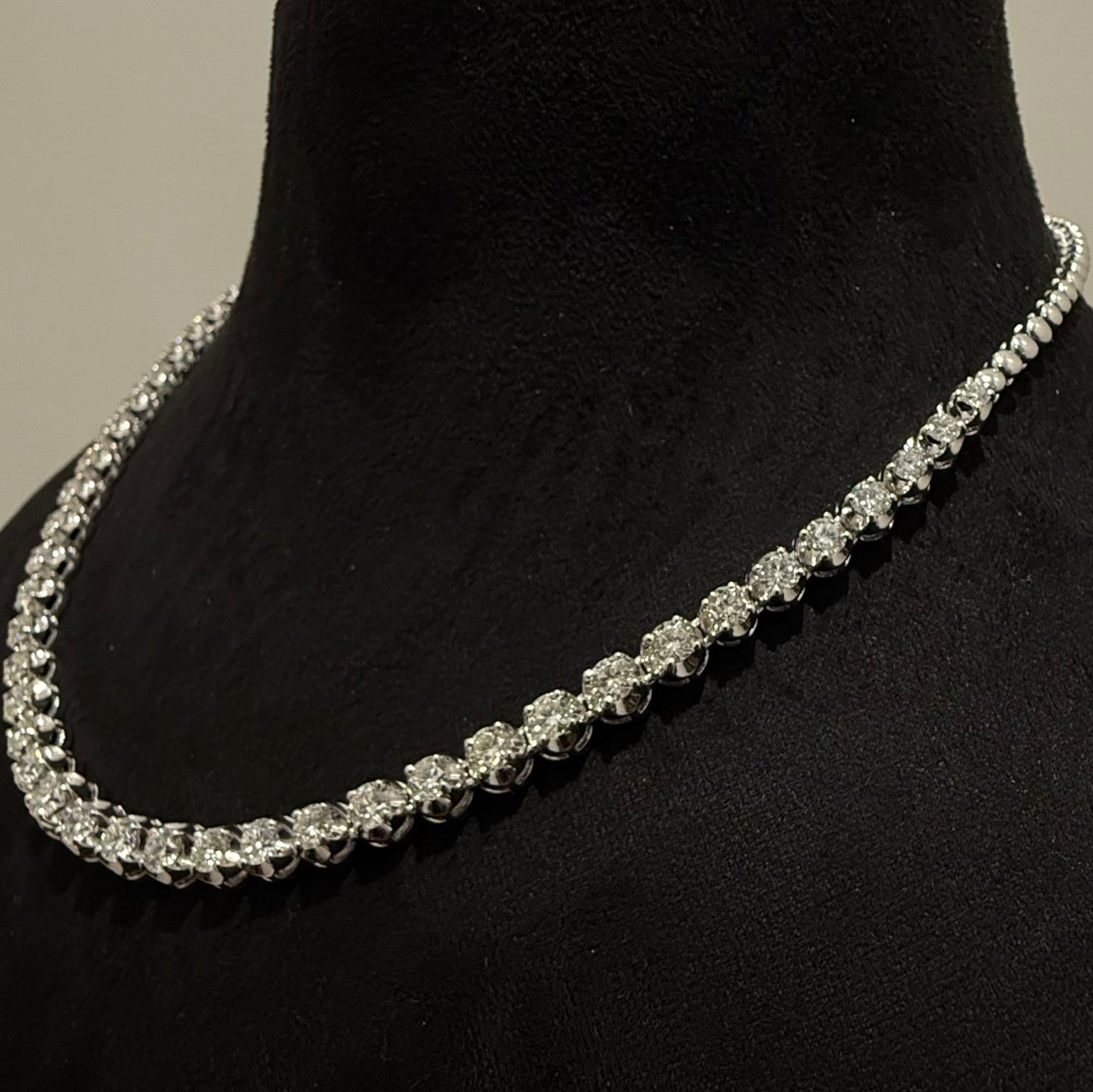 White gold diamond tennis necklace on a black mannequin