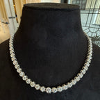 White gold diamond tennis necklace on a black mannequin bust