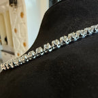 Diamond tennis necklace with clear diamonds on a black surface