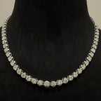 White gold and diamond tennis necklace on a black mannequin