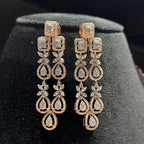 Pair of diamond earrings on a black stand