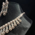 Diamond necklace and earrings on a black stand