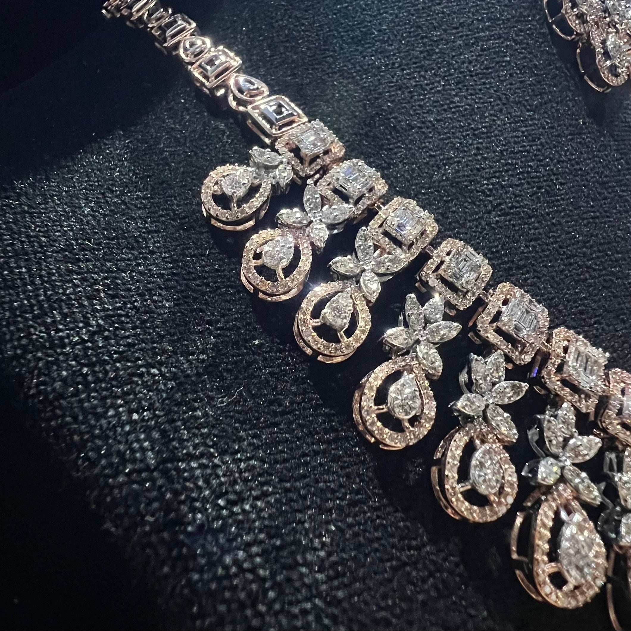 Delicate diamond necklace on a black textured surface