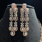 Pair of diamond earrings on a black jewelry stand