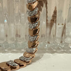 Rose gold bracelet with diamonds on a clear glass background